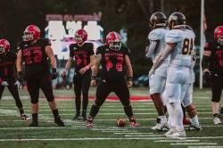 Red Hawks offensive lineman Cameron Siebert stands midfield.